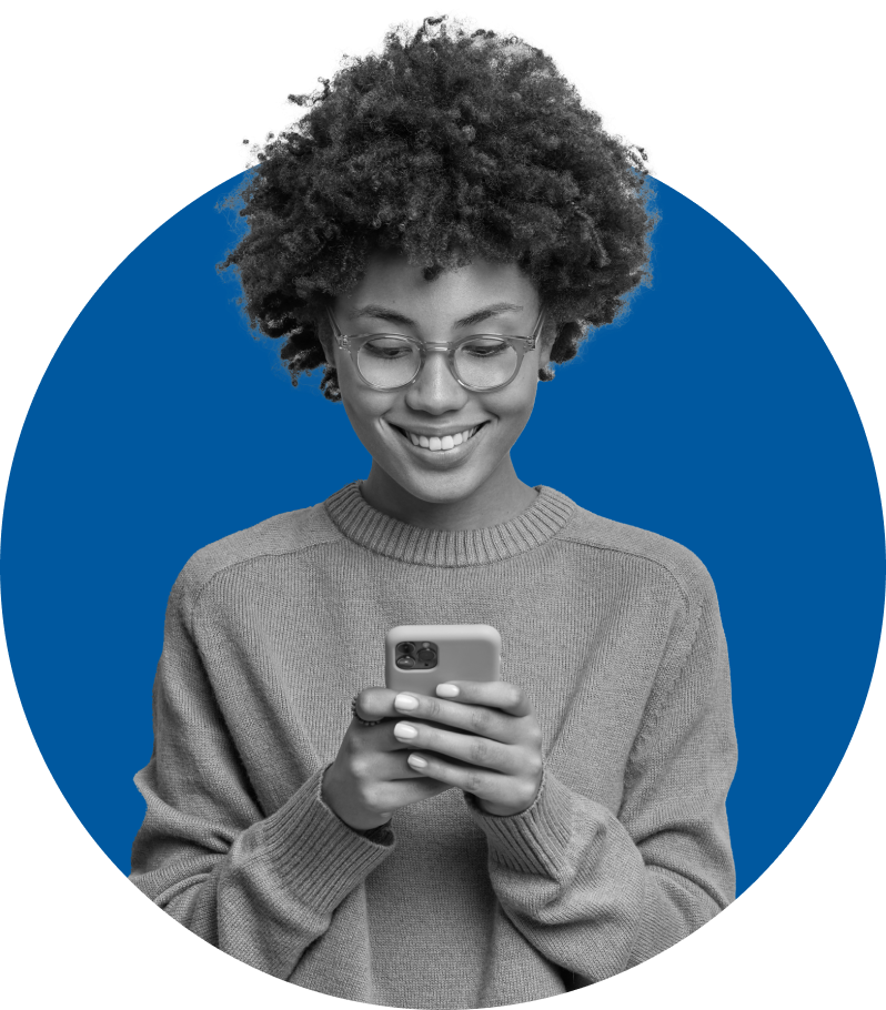 Smiling woman looks at the screen of her mobile phone